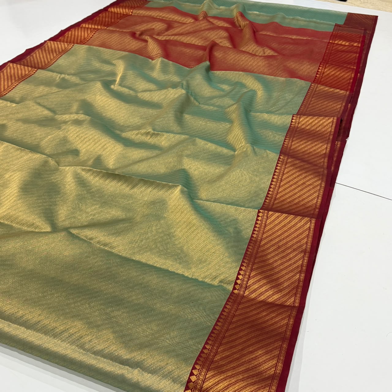 Dual-tone olive green and gold Chanderi Handloom Katan Silk saree with a rich maroon border and intricate Nakshi weaving.