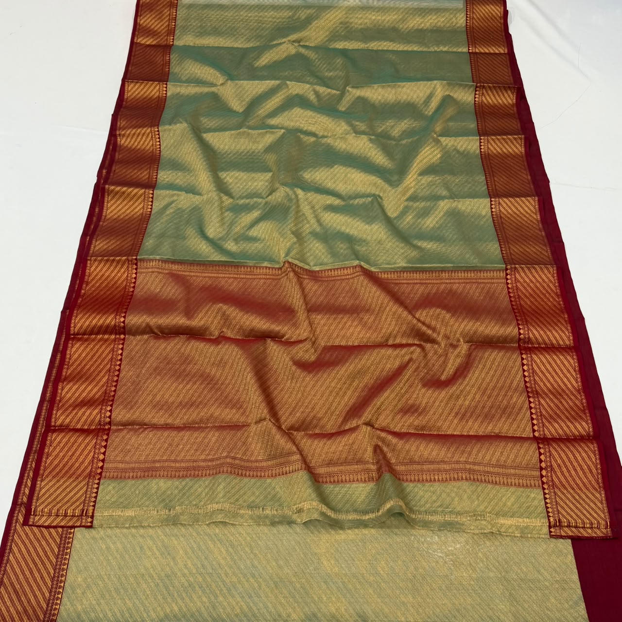 Dual-tone olive green and gold Chanderi Handloom Katan Silk saree with a rich maroon border and intricate Nakshi weaving.