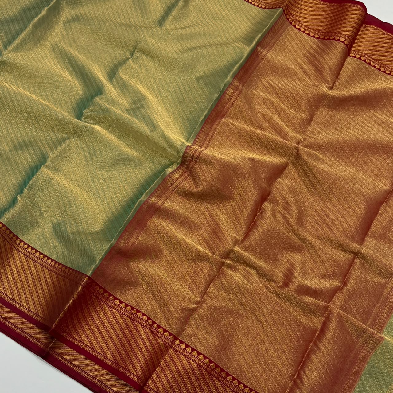 Dual-tone olive green and gold Chanderi Handloom Katan Silk saree with a rich maroon border and intricate Nakshi weaving.