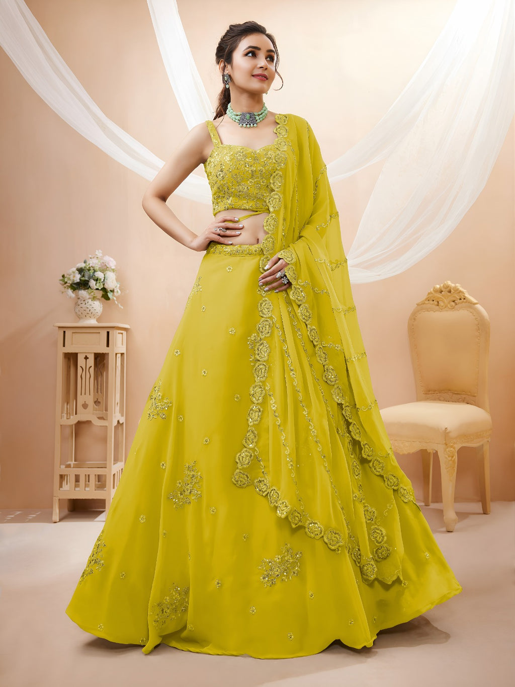 Model wearing a stunning lime green designer lehenga choli featuring intricate embroidery and a matching sheer dupatta