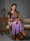 A model wearing a vibrant Gadwal Semi Pattu silk saree with intricate zari borders and a contrasting pallu.