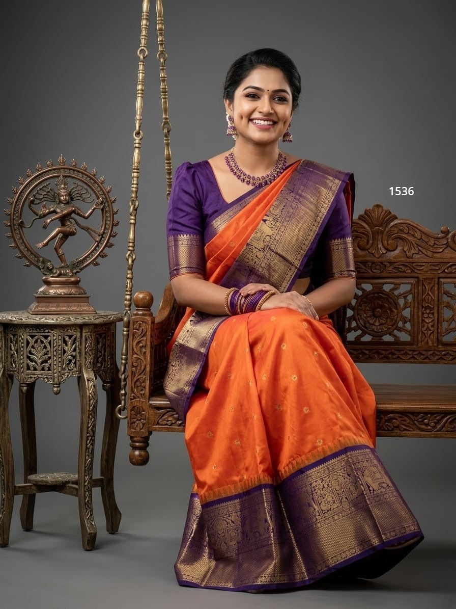 A model wearing a vibrant Gadwal Semi Pattu silk saree with intricate zari borders and a contrasting pallu.