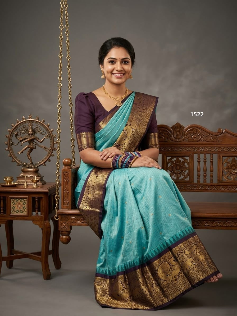 A model wearing a vibrant Gadwal Semi Pattu silk saree with intricate zari borders and a contrasting pallu.