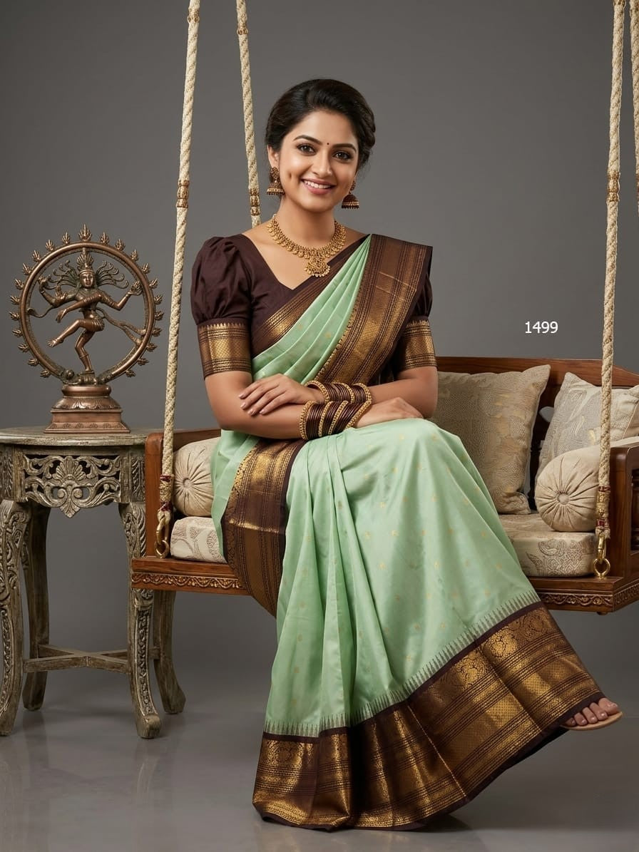 A model wearing a vibrant Gadwal Semi Pattu silk saree with intricate zari borders and a contrasting pallu.