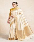 Ivory Banarasi Raw Mango Silk saree with horizontal Gold and Silver zari stripes, Kaduwa weaving, and a mustard yellow blouse.