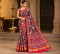 Model wearing a rustic red Patan Patola pure mulberry silk saree featuring an elaborate double ikat figurative design with traditional borders and pallu.