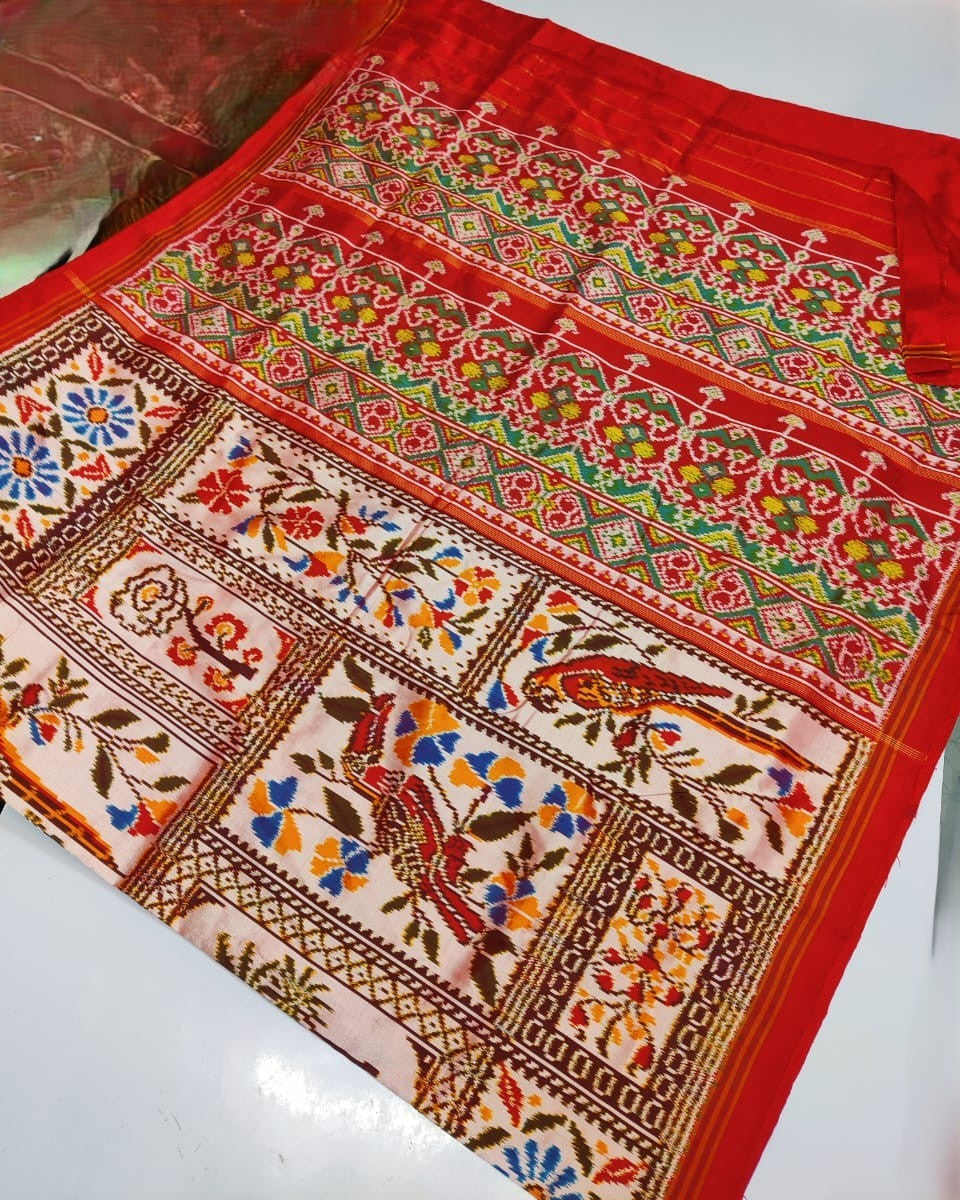 Red Pochampally Handloom Ikat Madthasu Patola Silk Saree featuring traditional double warp Ikat motifs, figurative panels, and a rich red pallu.