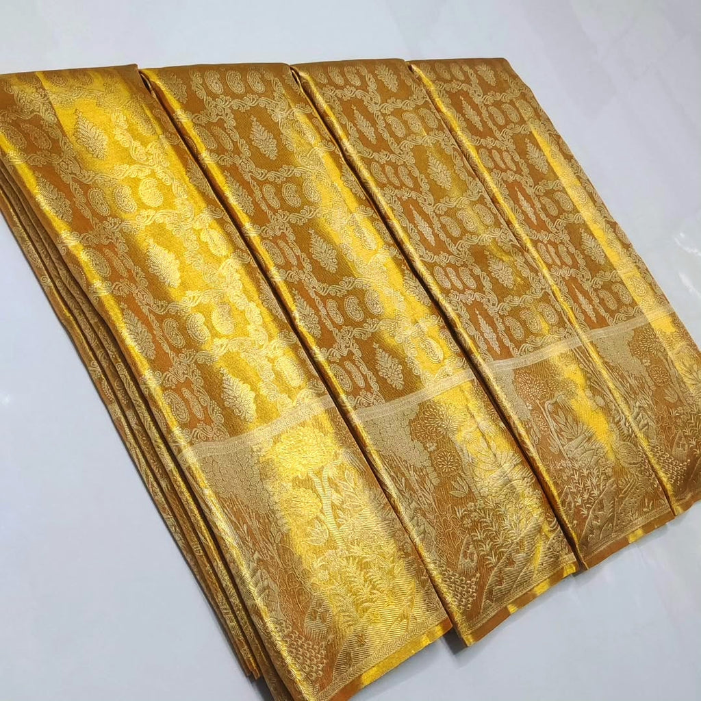 Gold Kanchipuram Handloom Tissue Brocade Silk Saree, a garment that defines the "liquid gold" look of South Indian royalty. 
