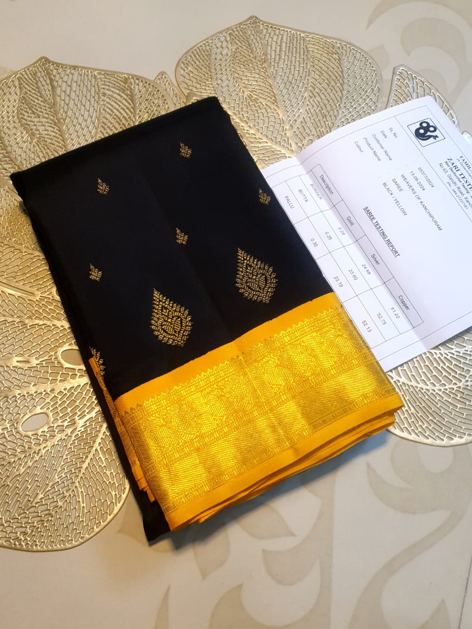 A luxurious black Kanchipuram handloom 4G pure gold pattu silk saree featuring intricate traditional motifs and a lustrous weave.