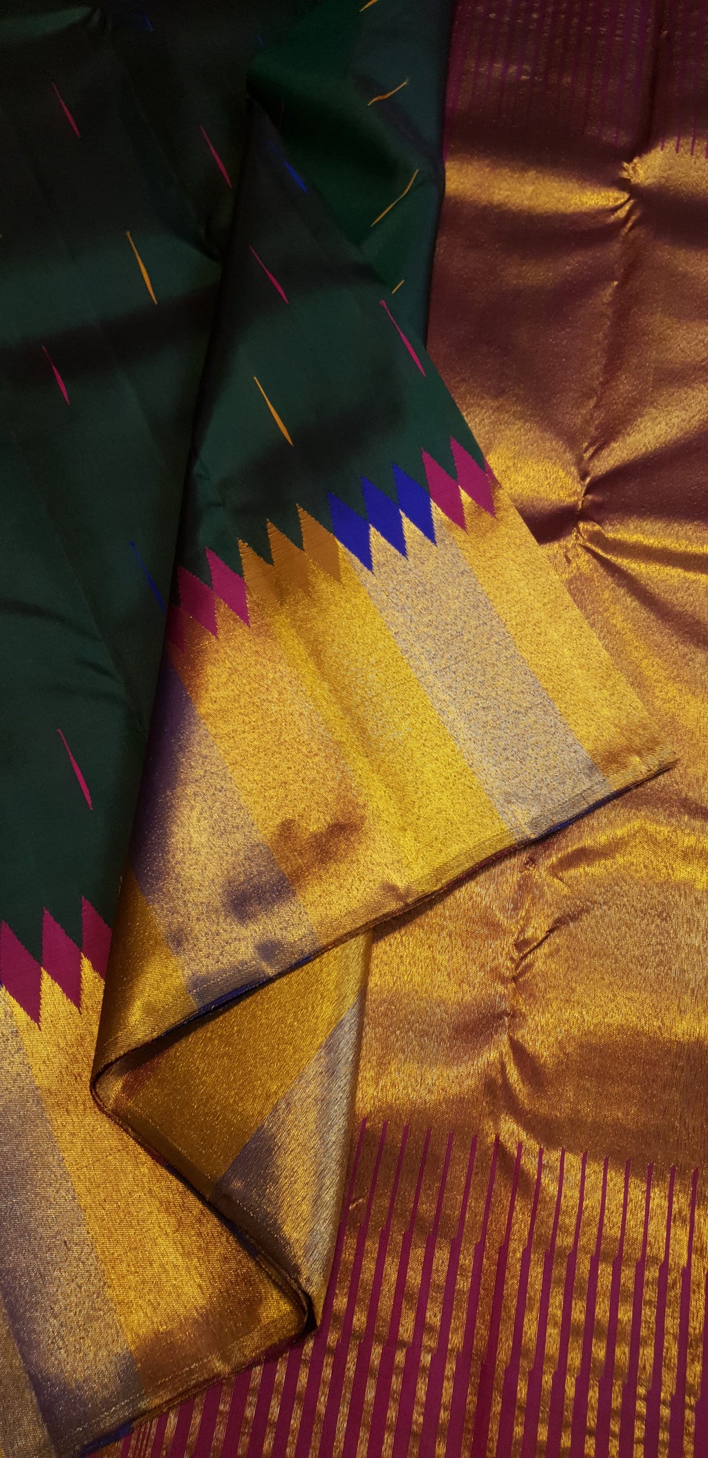 Bottle green Kanchipuram handloom 2G silk saree with 8-color temple border, traditional gold zari, and vibrant purple accents, perfect for weddings and festive occasions.