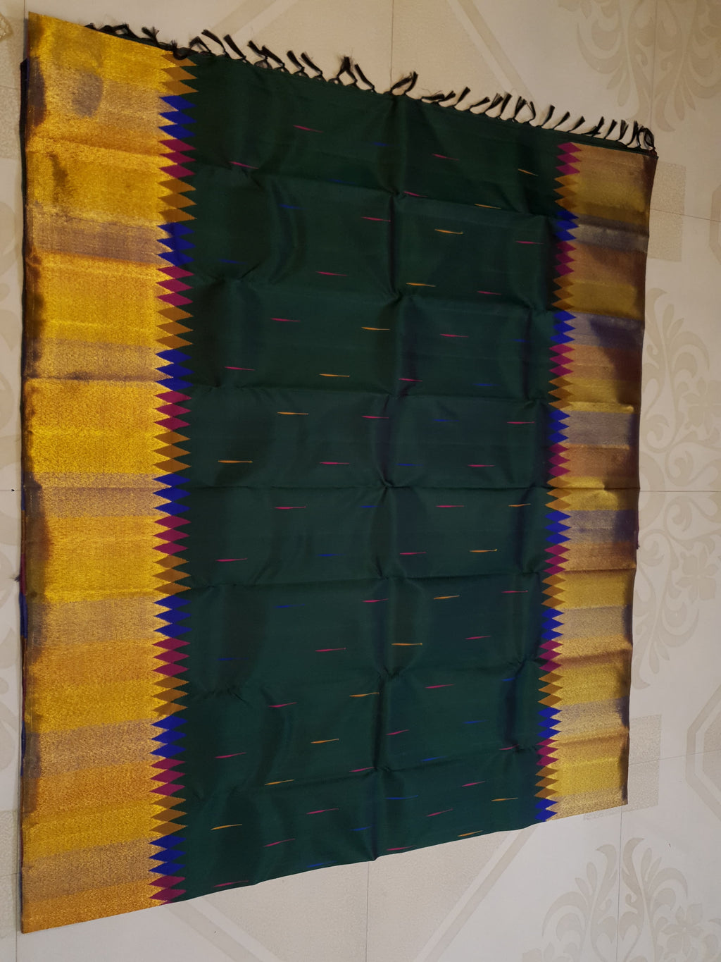 Bottle green Kanchipuram handloom 2G silk saree with 8-color temple border, traditional gold zari, and vibrant purple accents, perfect for weddings and festive occasions.