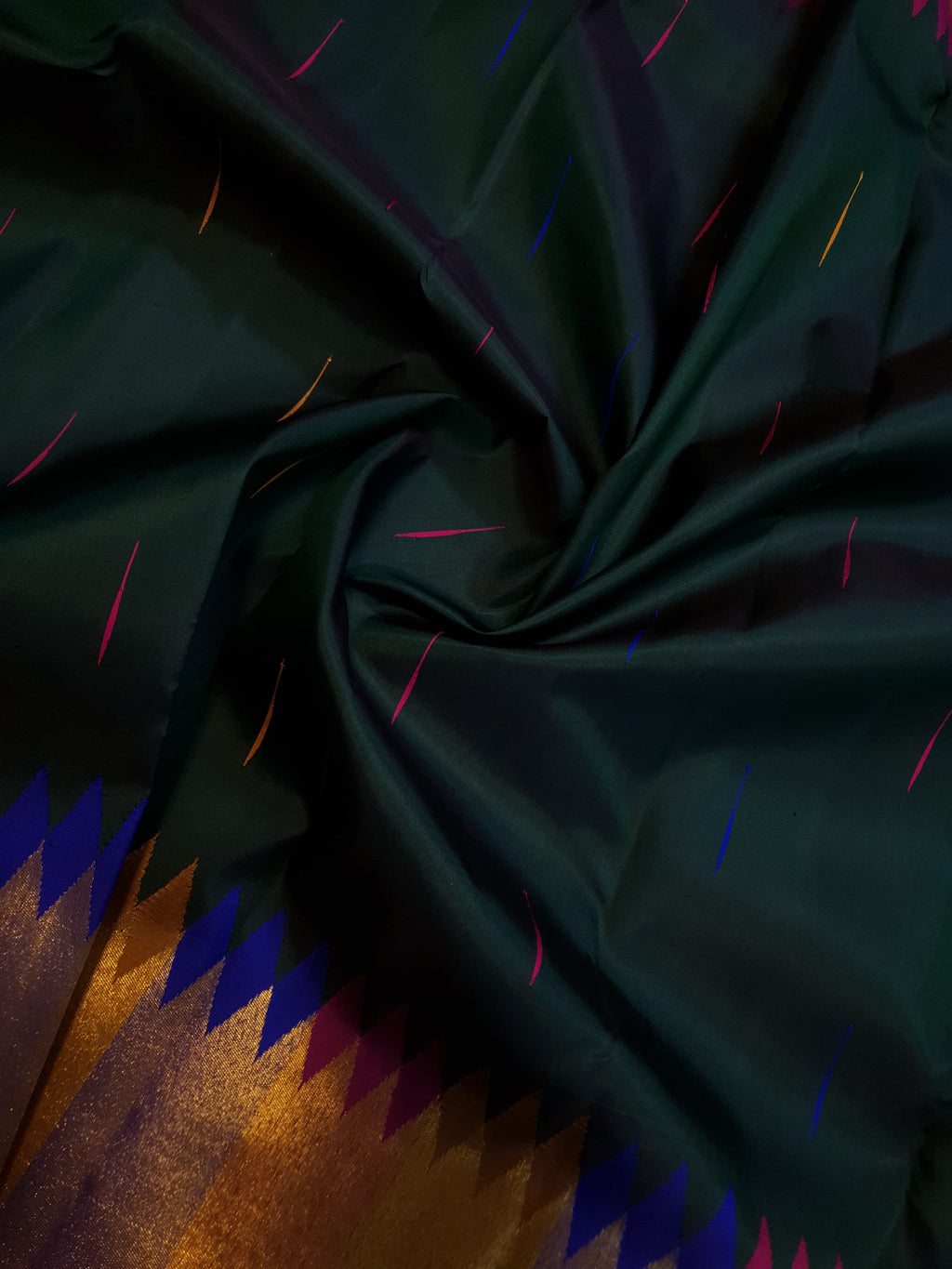 Bottle green Kanchipuram handloom 2G silk saree with 8-color temple border, traditional gold zari, and vibrant purple accents, perfect for weddings and festive occasions.