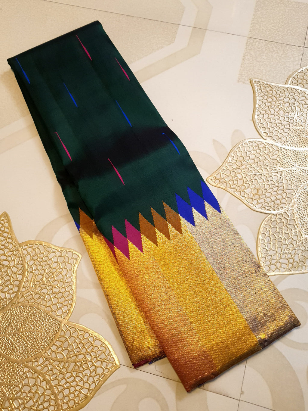 Bottle green Kanchipuram handloom 2G silk saree with 8-color temple border, traditional gold zari, and vibrant purple accents, perfect for weddings and festive occasions.