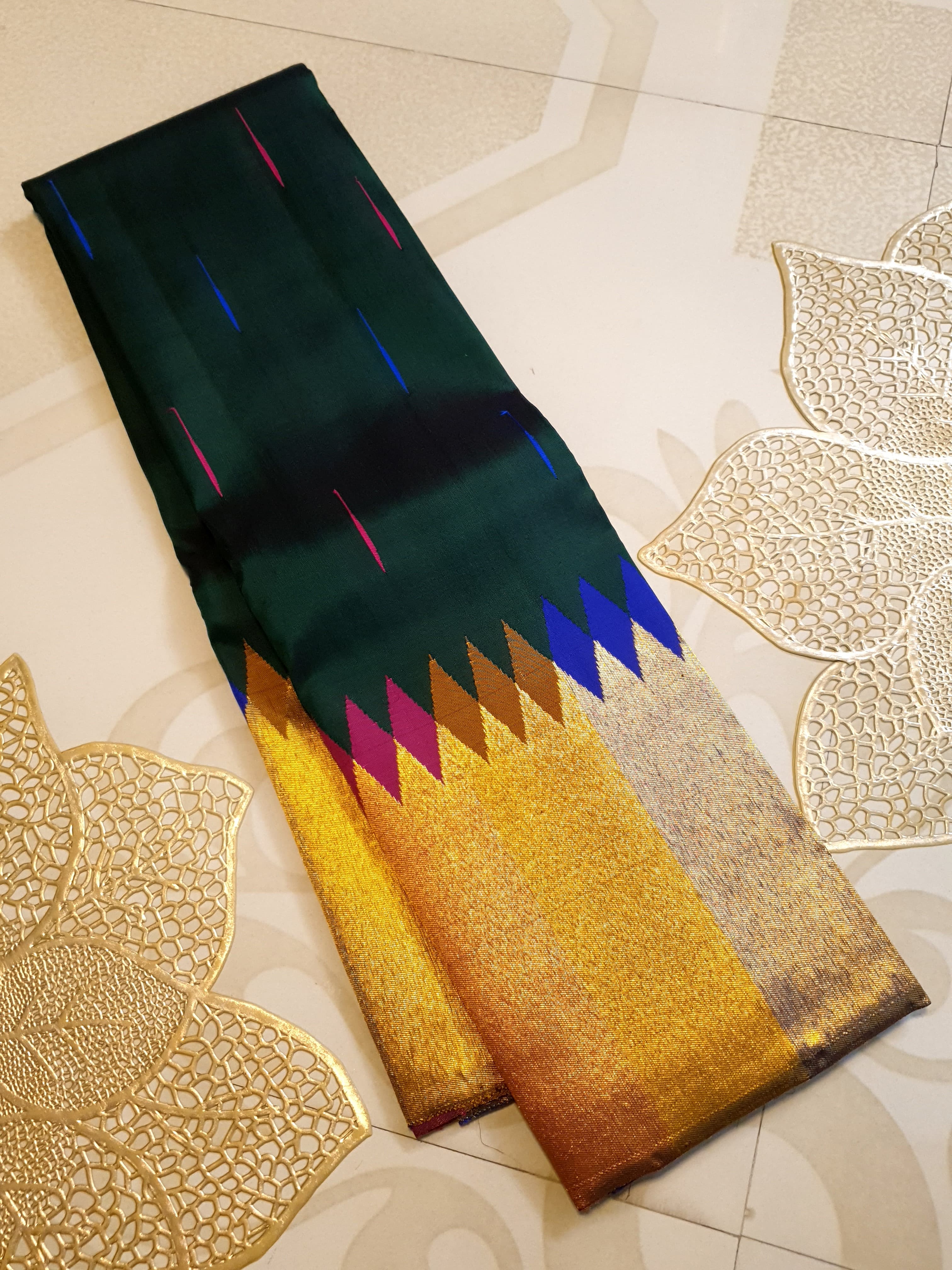 Bottle green Kanchipuram handloom 2G silk saree with 8-color temple border, traditional gold zari, and vibrant purple accents, perfect for weddings and festive occasions.