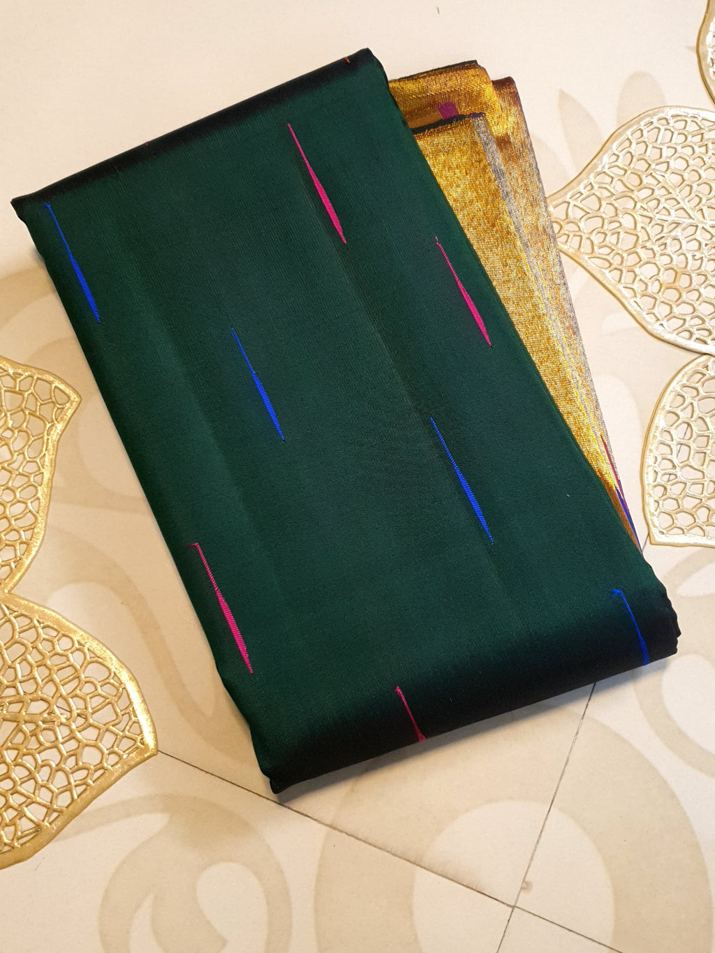 Bottle green Kanchipuram handloom 2G silk saree with 8-color temple border, traditional gold zari, and vibrant purple accents, perfect for weddings and festive occasions.