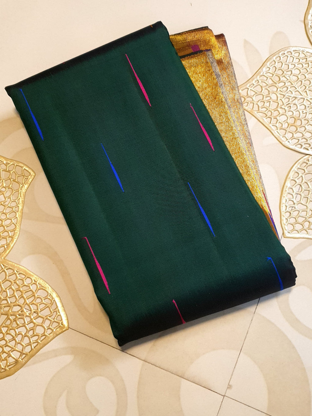 Bottle green Kanchipuram handloom 2G silk saree with 8-color temple border, traditional gold zari, and vibrant purple accents, perfect for weddings and festive occasions.