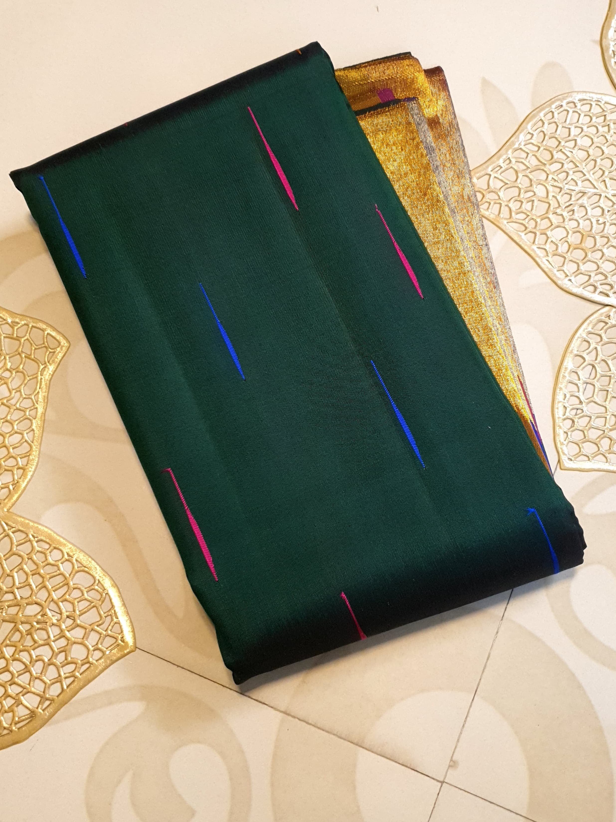 Bottle green Kanchipuram handloom 2G silk saree with 8-color temple border, traditional gold zari, and vibrant purple accents, perfect for weddings and festive occasions.