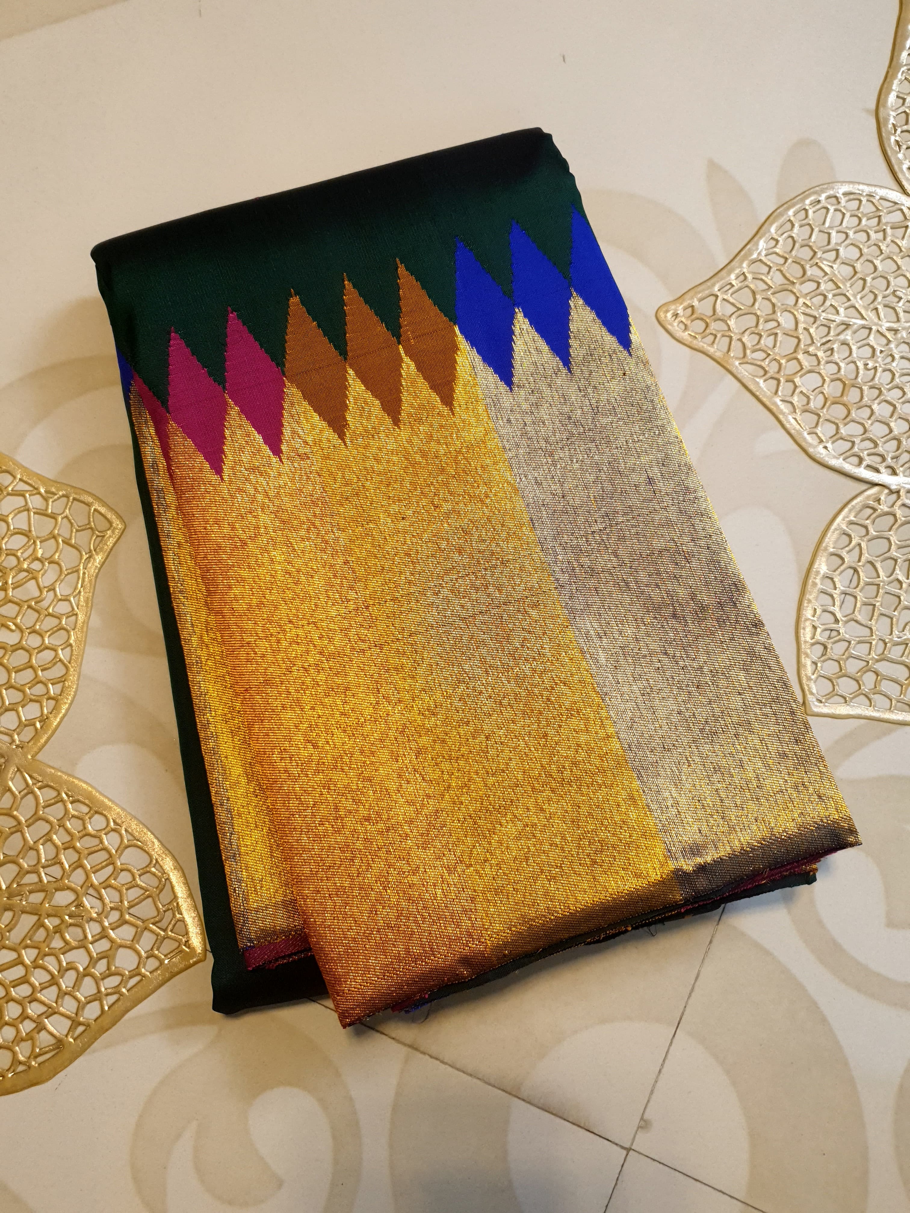 Bottle green Kanchipuram handloom 2G silk saree with 8-color temple border, traditional gold zari, and vibrant purple accents, perfect for weddings and festive occasions.