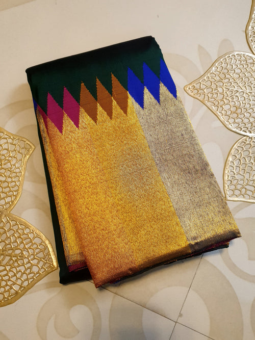 Bottle green Kanchipuram handloom 2G silk saree with 8-color temple border, traditional gold zari, and vibrant purple accents, perfect for weddings and festive occasions.