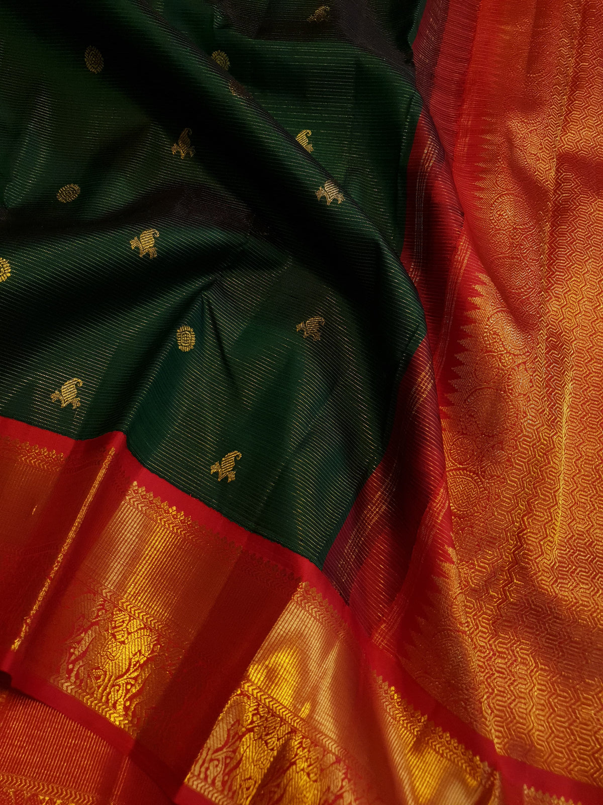 Bottle Green Kanchipuram Handloom 2G Gold Vairaoosi Silk Saree with all-over fine stripes, traditional buttas, and rich contrasting red and gold borders and pallu.