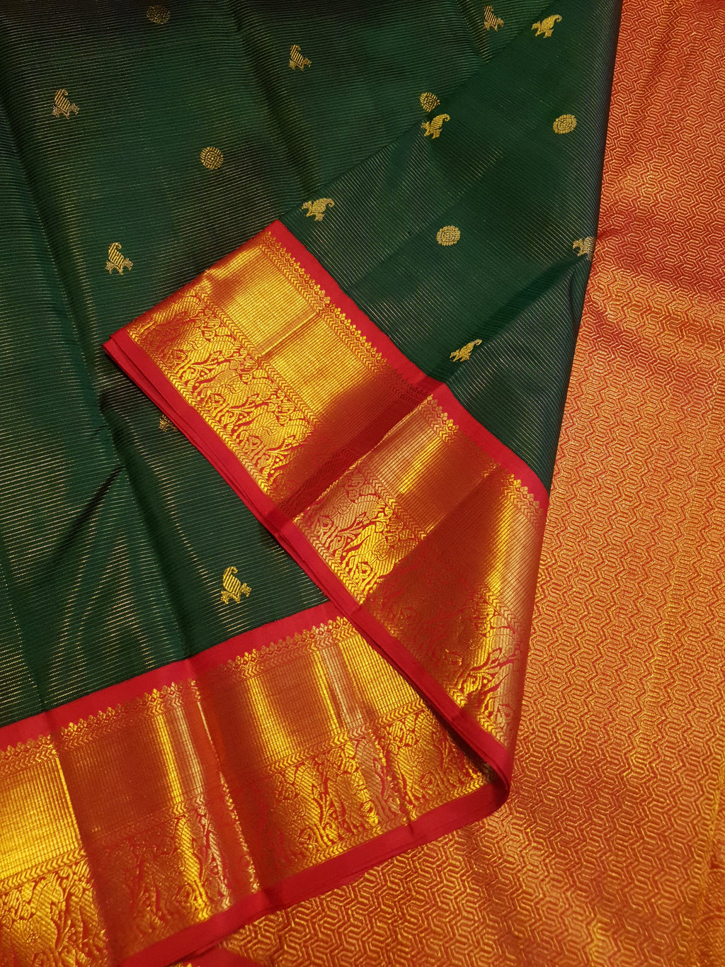 Bottle Green Kanchipuram Handloom 2G Gold Vairaoosi Silk Saree with all-over fine stripes, traditional buttas, and rich contrasting red and gold borders and pallu.
