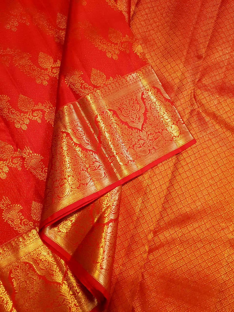 Exquisite Chilly Red Kanchipuram handloom silk saree with intricate gold zari detailing, styled for a traditional wedding look.