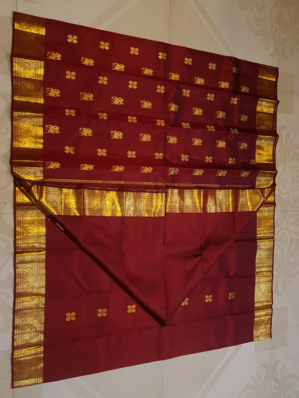 Maroon Kanchipuram handloom 2G gold bridal silk saree featuring traditional elephant zari borders and intricate woven buttas.