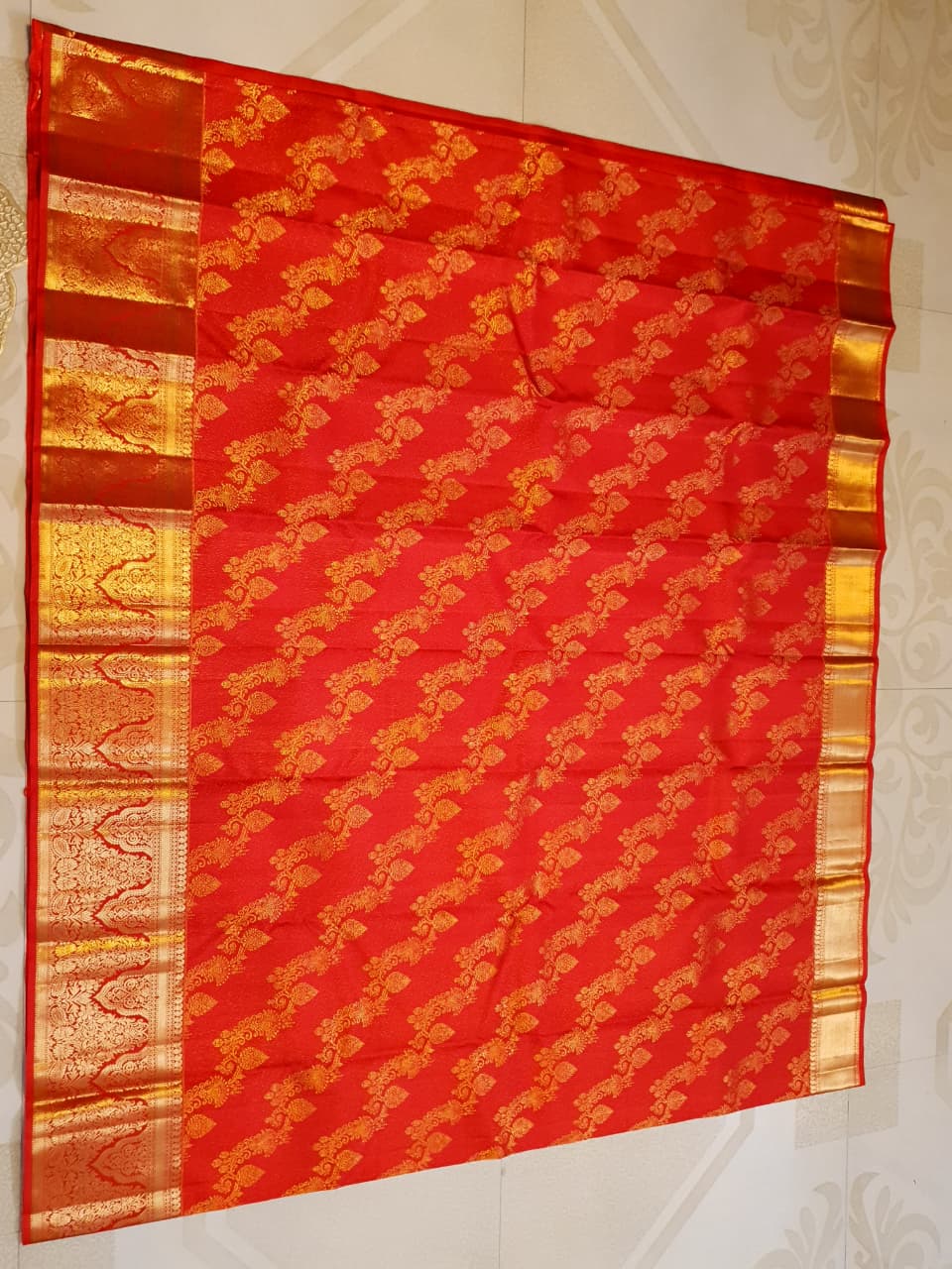 Exquisite Chilly Red Kanchipuram handloom silk saree with intricate gold zari detailing, styled for a traditional wedding look.