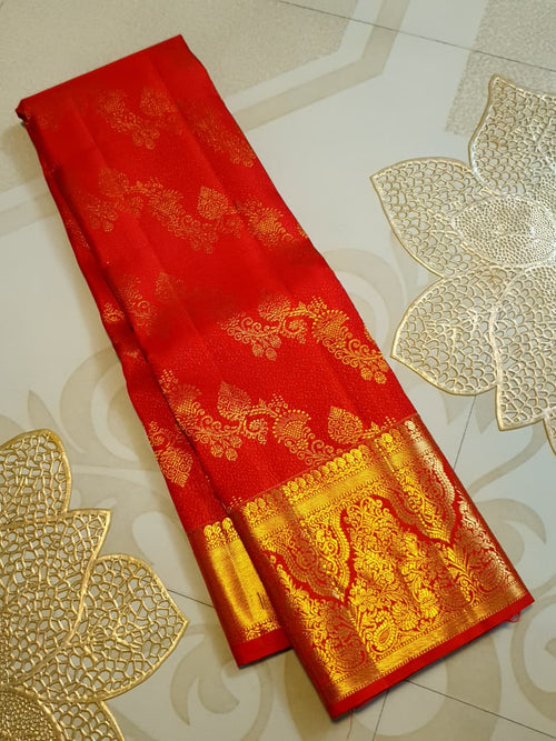 Exquisite Chilly Red Kanchipuram handloom silk saree with intricate gold zari detailing, styled for a traditional wedding look.