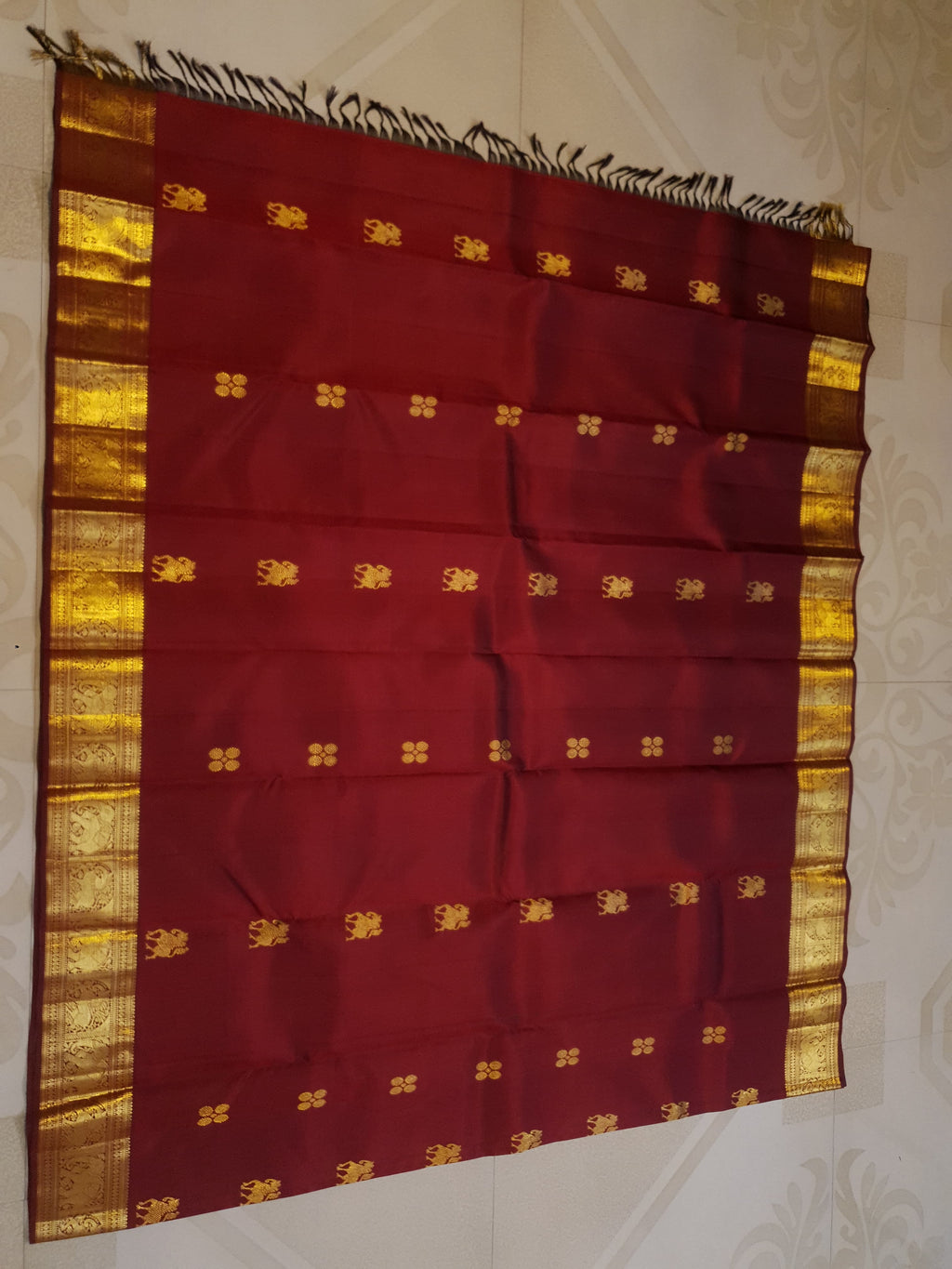 Maroon Kanchipuram handloom 2G gold bridal silk saree featuring traditional elephant zari borders and intricate woven buttas.