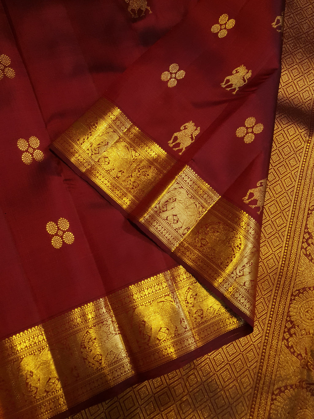 Maroon Kanchipuram handloom 2G gold bridal silk saree featuring traditional elephant zari borders and intricate woven buttas.