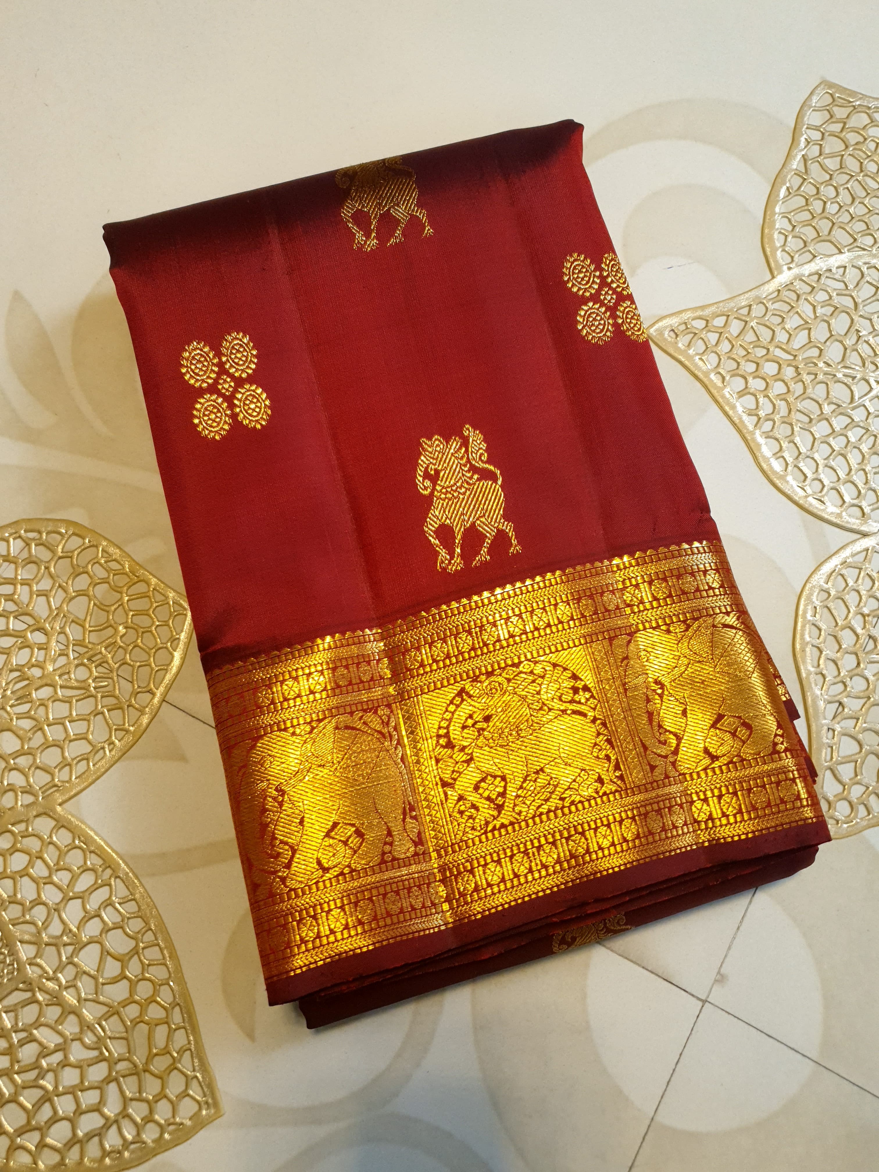 Maroon Kanchipuram handloom 2G gold bridal silk saree featuring traditional elephant zari borders and intricate woven buttas.
