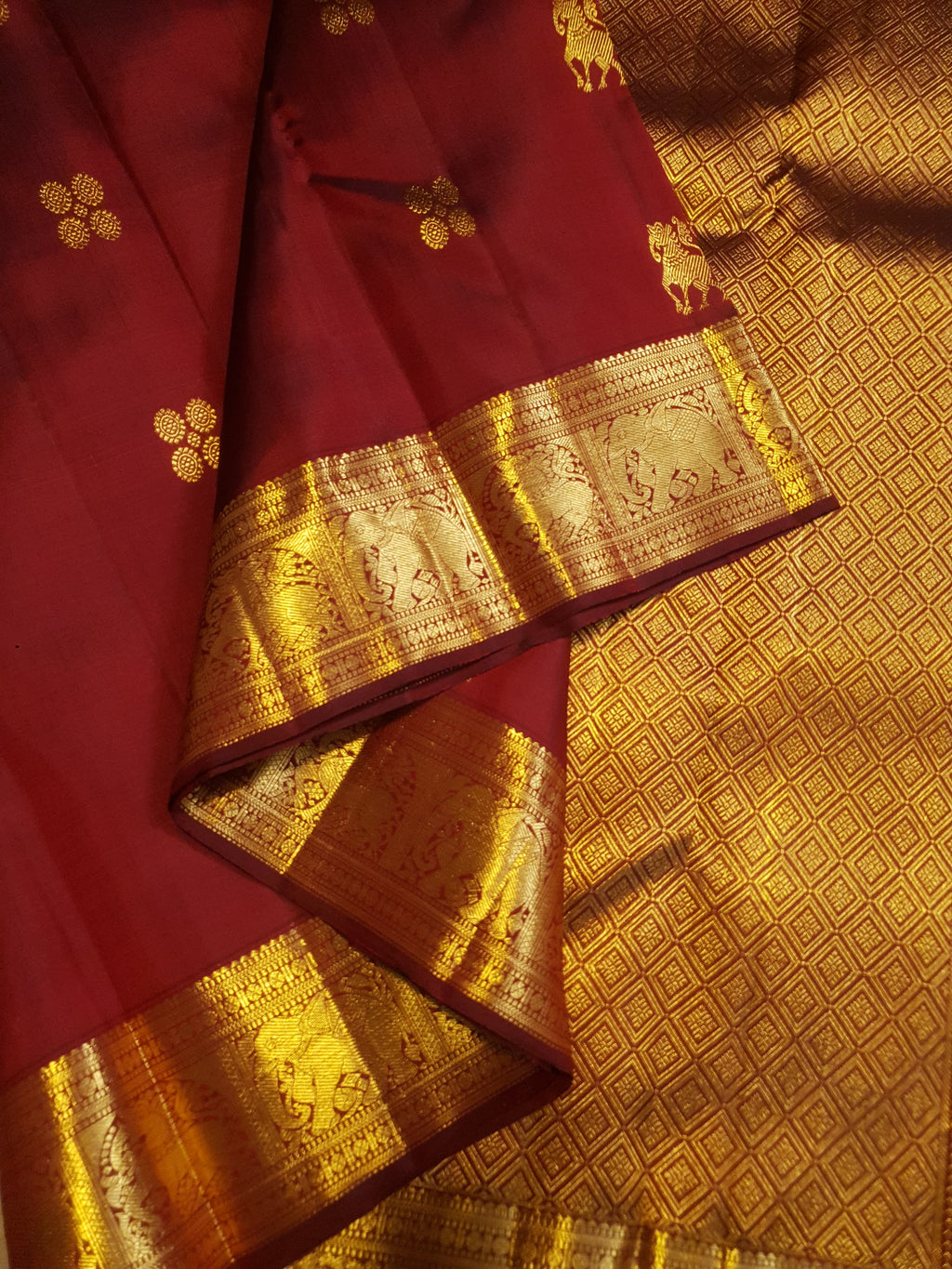 Maroon Kanchipuram handloom 2G gold bridal silk saree featuring traditional elephant zari borders and intricate woven buttas.