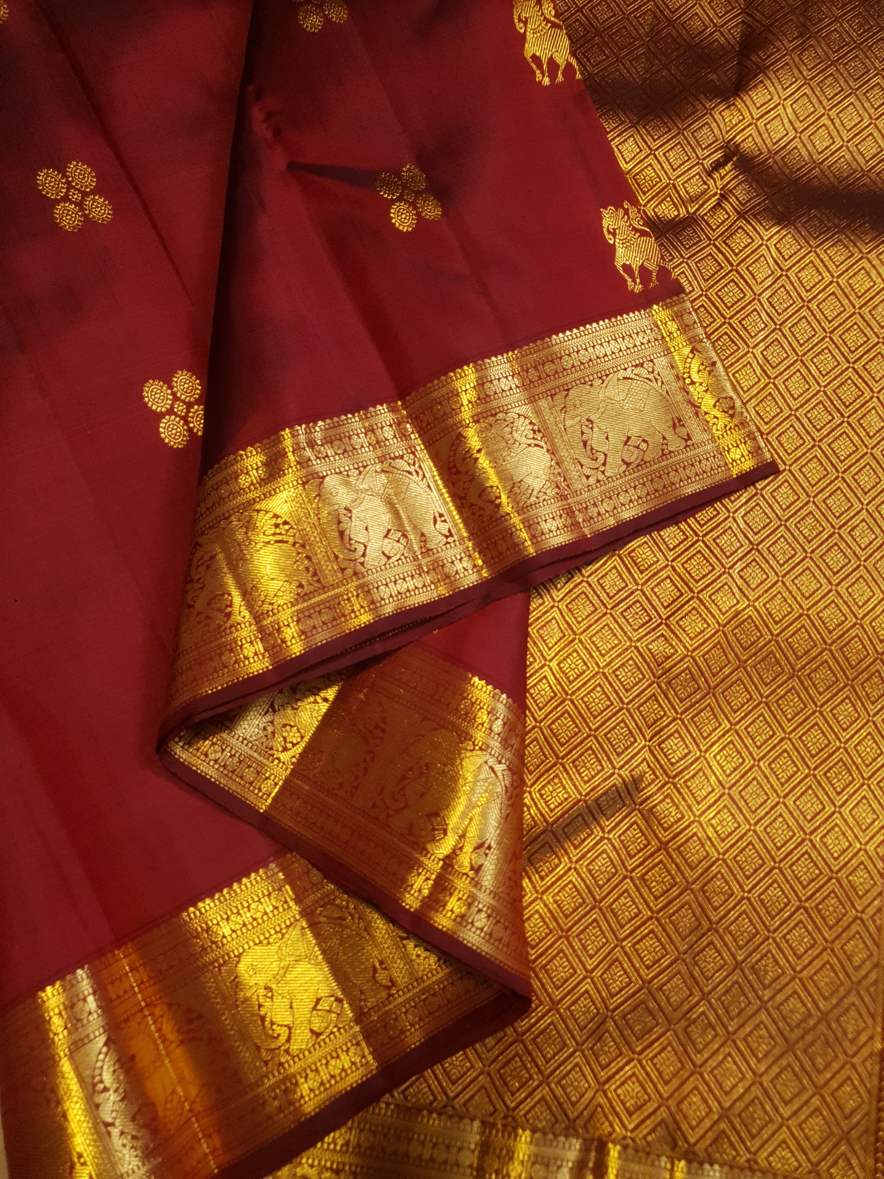 Maroon Kanchipuram handloom 2G gold bridal silk saree featuring traditional elephant zari borders and intricate woven buttas.