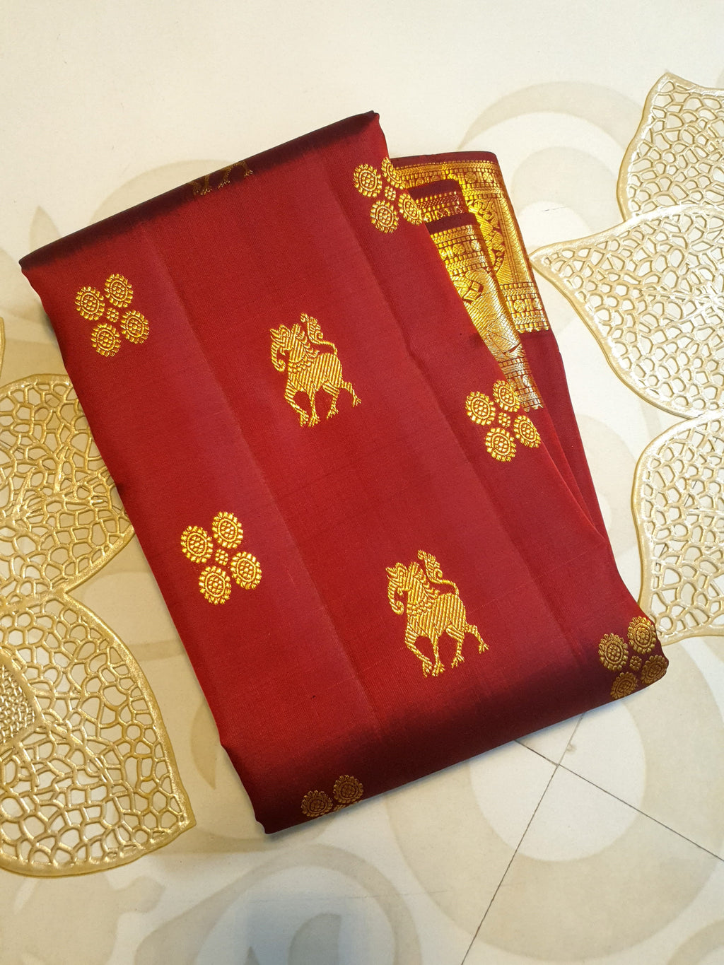 Maroon Kanchipuram handloom 2G gold bridal silk saree featuring traditional elephant zari borders and intricate woven buttas.