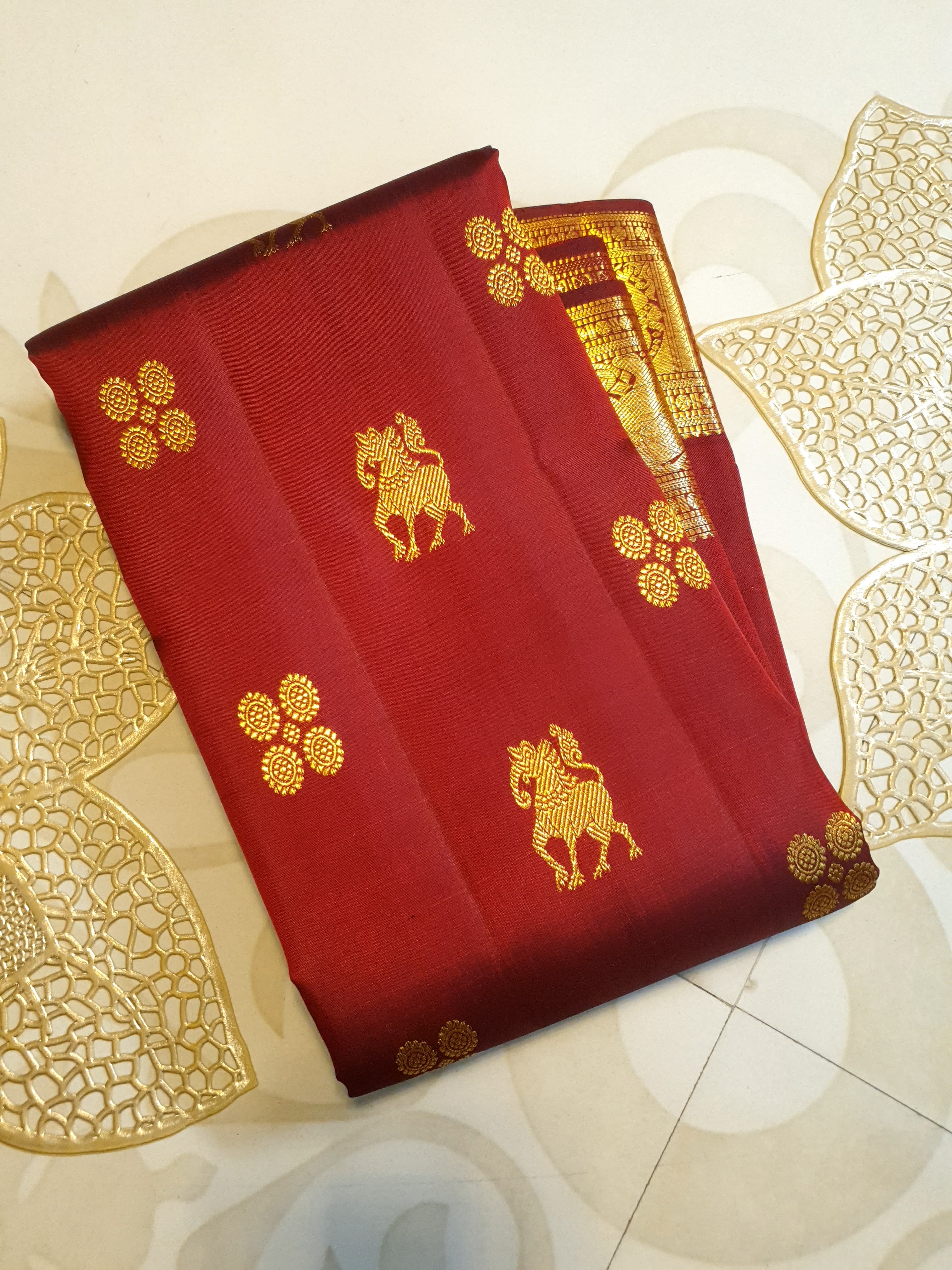 Maroon Kanchipuram handloom 2G gold bridal silk saree featuring traditional elephant zari borders and intricate woven buttas.