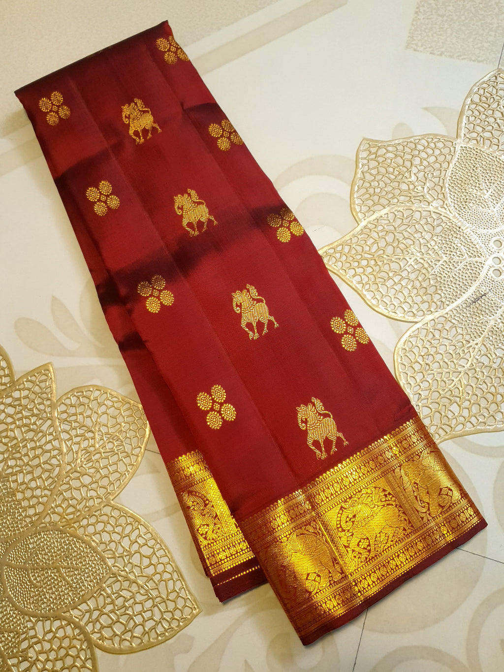 Maroon Kanchipuram handloom 2G gold bridal silk saree featuring traditional elephant zari borders and intricate woven buttas.
