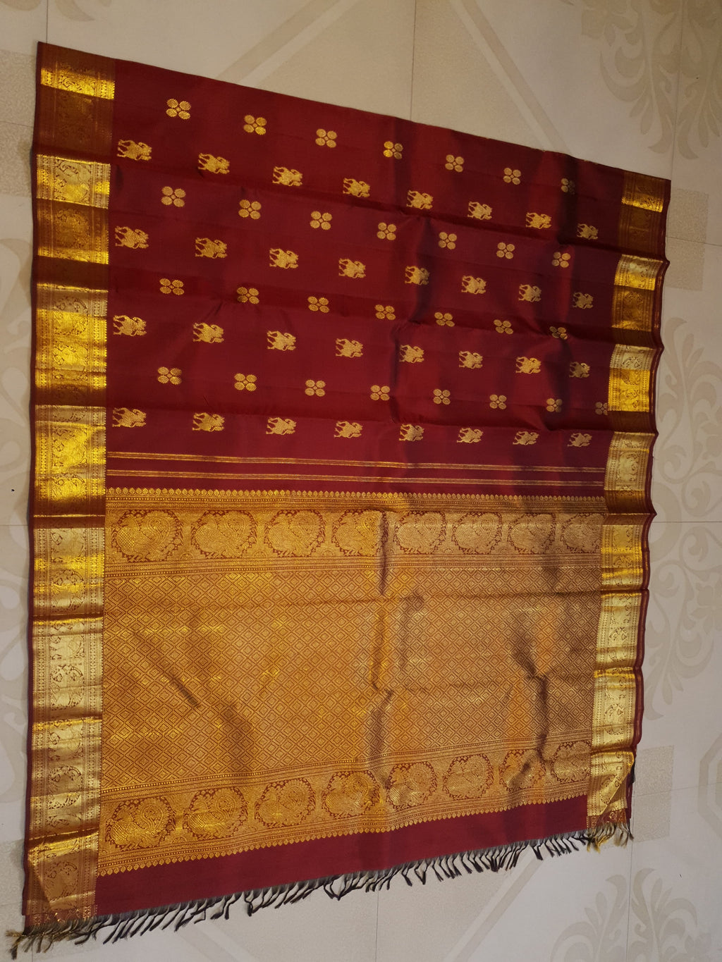 Maroon Kanchipuram handloom 2G gold bridal silk saree featuring traditional elephant zari borders and intricate woven buttas.