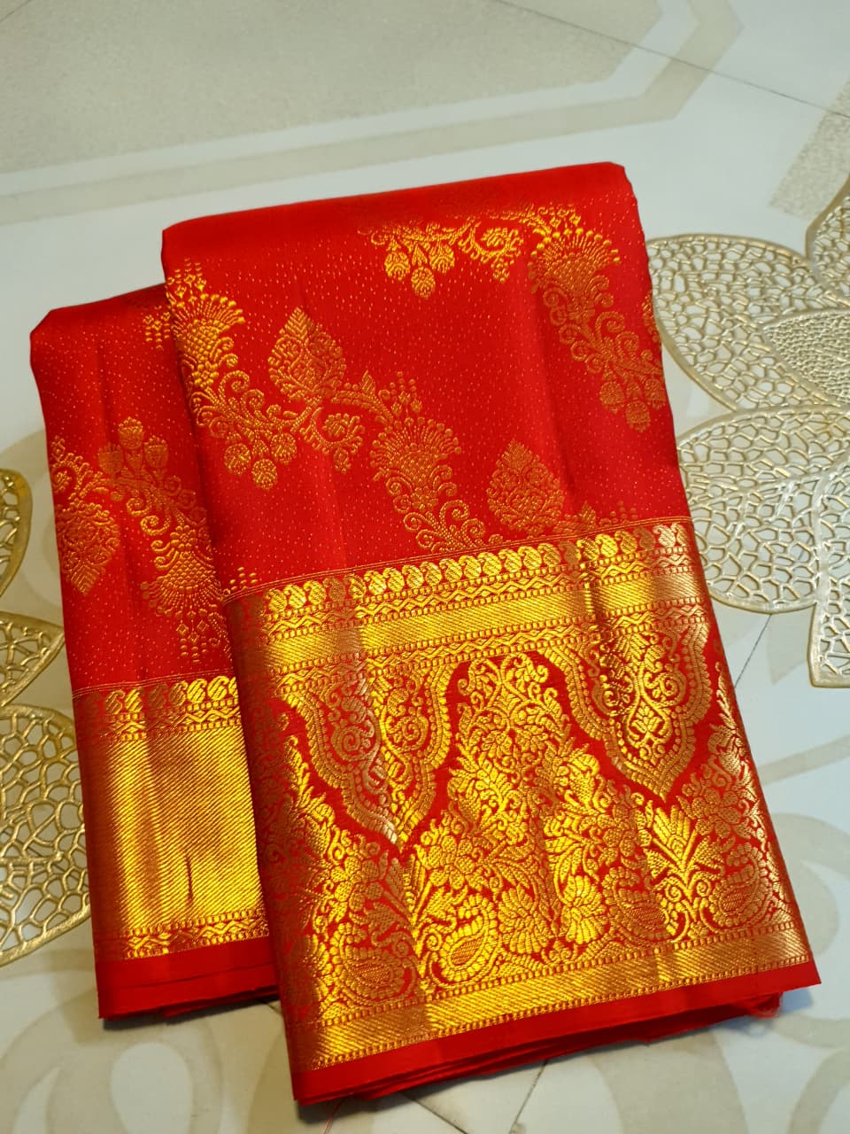 Exquisite Chilly Red Kanchipuram handloom silk saree with intricate gold zari detailing, styled for a traditional wedding look.