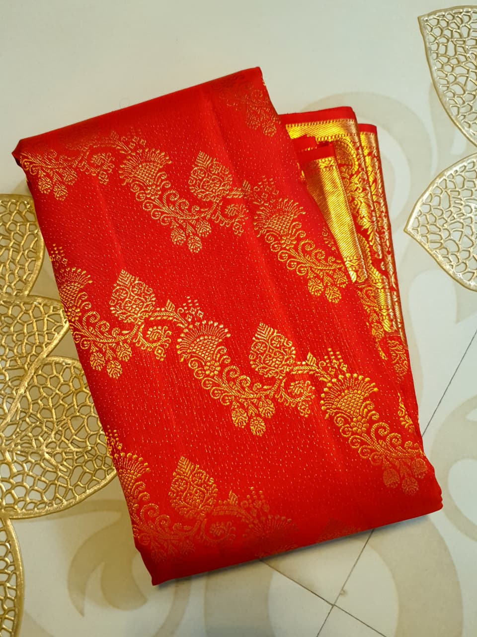 Exquisite Chilly Red Kanchipuram handloom silk saree with intricate gold zari detailing, styled for a traditional wedding look.