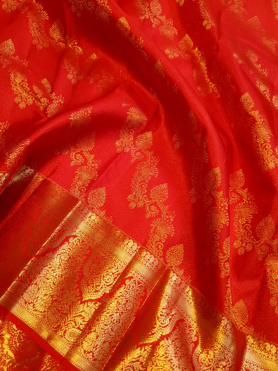 Exquisite Chilly Red Kanchipuram handloom silk saree with intricate gold zari detailing, styled for a traditional wedding look.