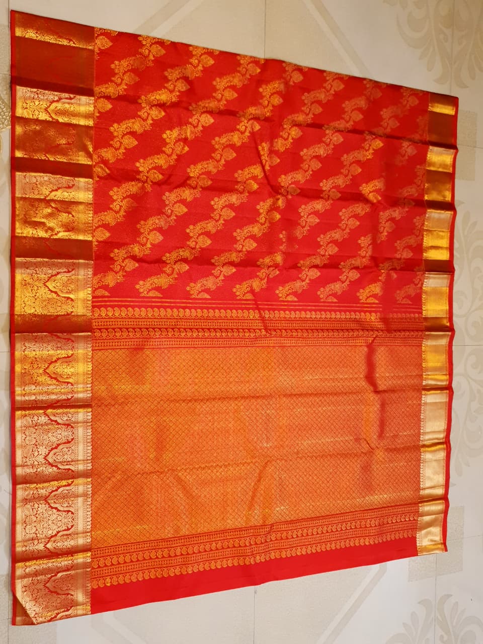 Exquisite Chilly Red Kanchipuram handloom silk saree with intricate gold zari detailing, styled for a traditional wedding look.