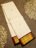 Cream Kanchipuram handloom Korvai Pattu silk saree featuring small 2G gold zari motifs, a rich contrast maroon pallu and border, and Silk Mark certification.