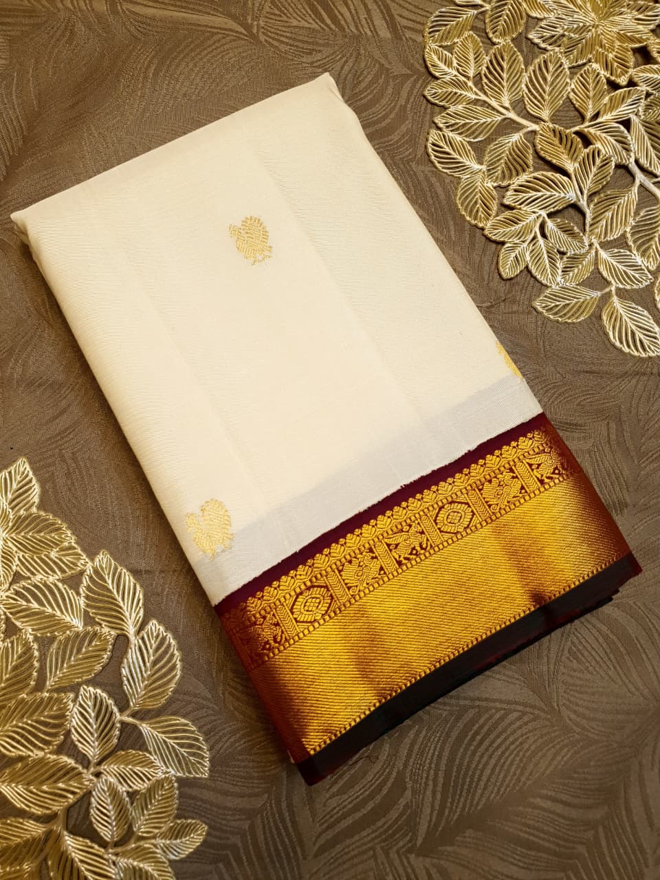 Cream Kanchipuram handloom Korvai Pattu silk saree featuring small 2G gold zari motifs, a rich contrast maroon pallu and border, and Silk Mark certification.