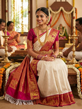 Cream Kanchipuram handloom silk saree with a vibrant pink and gold border, featuring intricate Kalyana Pallakku zari work, accessorized with traditional gold jewelry.