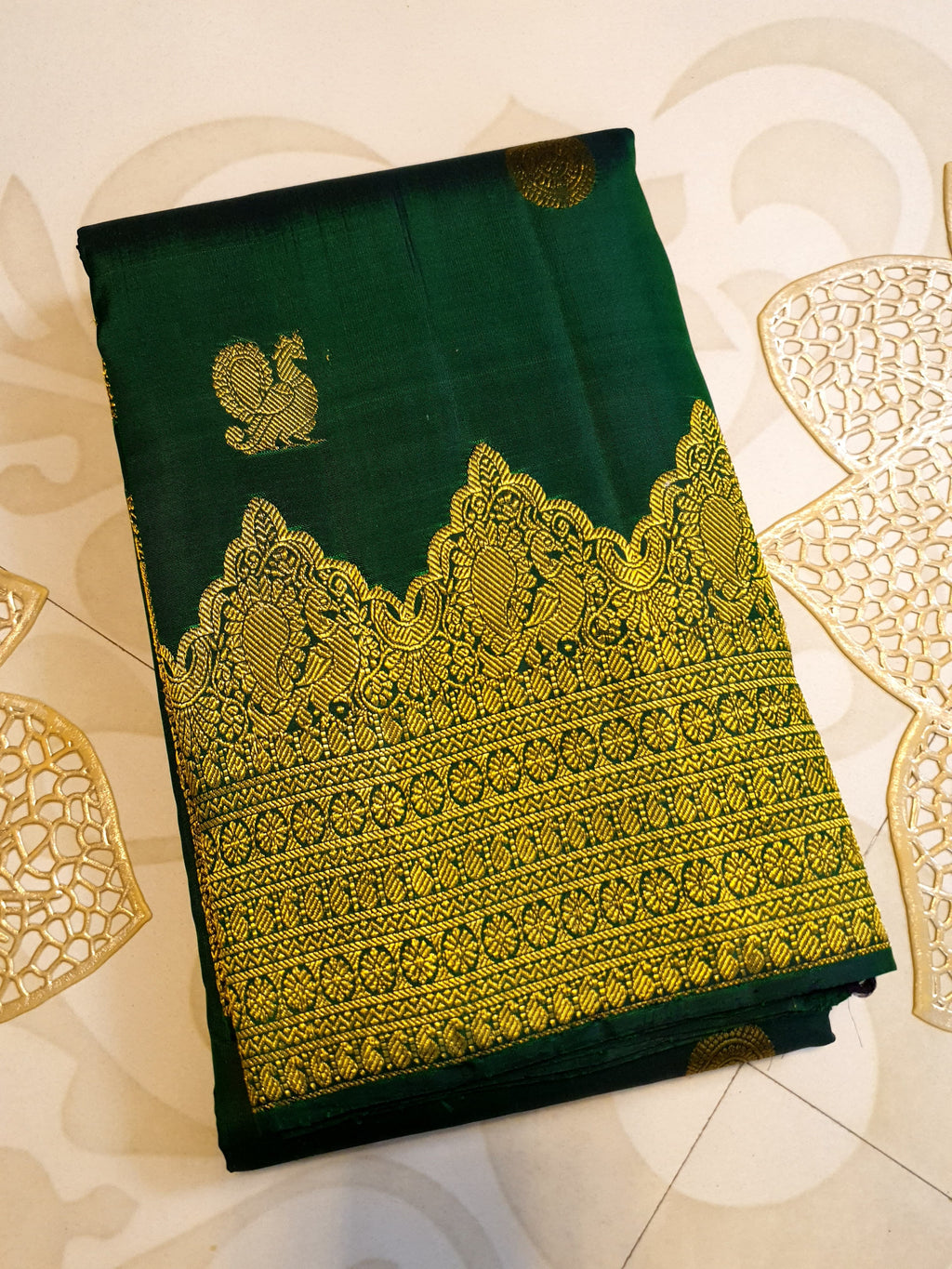 Bottle Green Kanchipuram handloom pattu silk saree featuring 2G gold zari motifs, a rich traditional border, and Silk Mark certification.