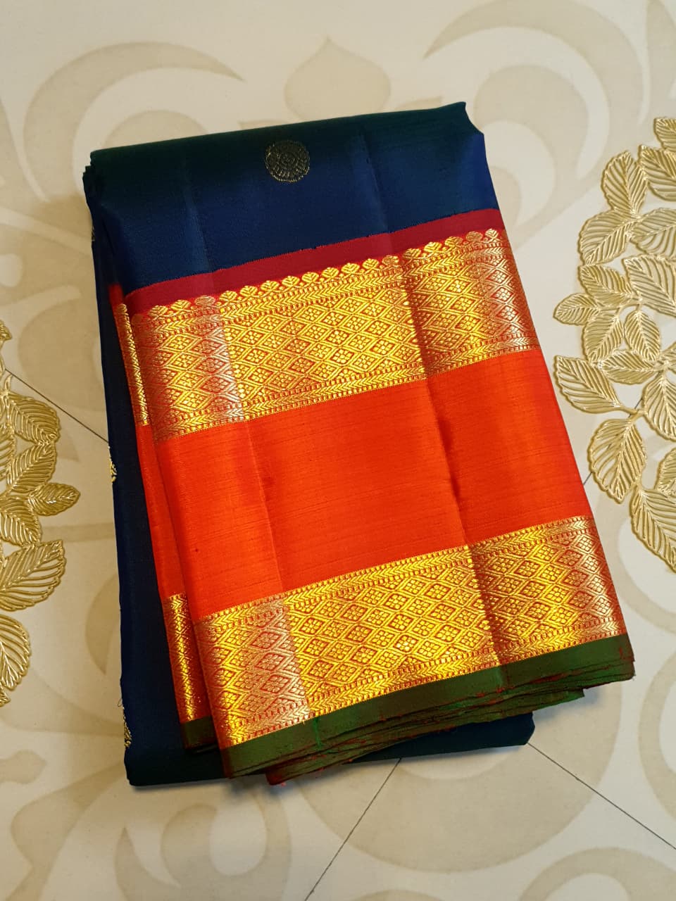 Midnight Blue Kanchipuram Handloom 2G Gold Korvai Silk Saree with contrasting orange gap borders and traditional motifs.