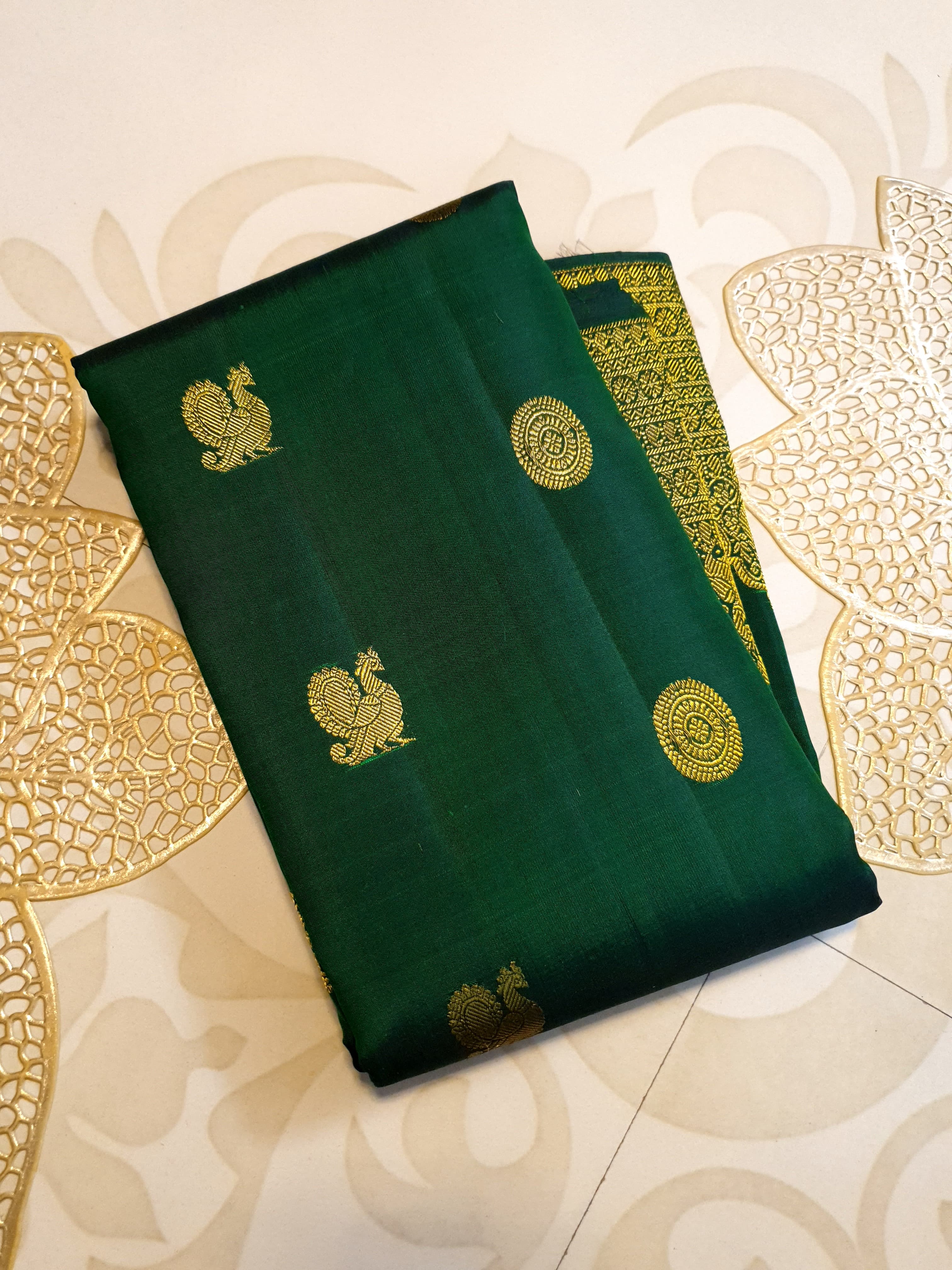 Bottle Green Kanchipuram handloom pattu silk saree featuring 2G gold zari motifs, a rich traditional border, and Silk Mark certification.