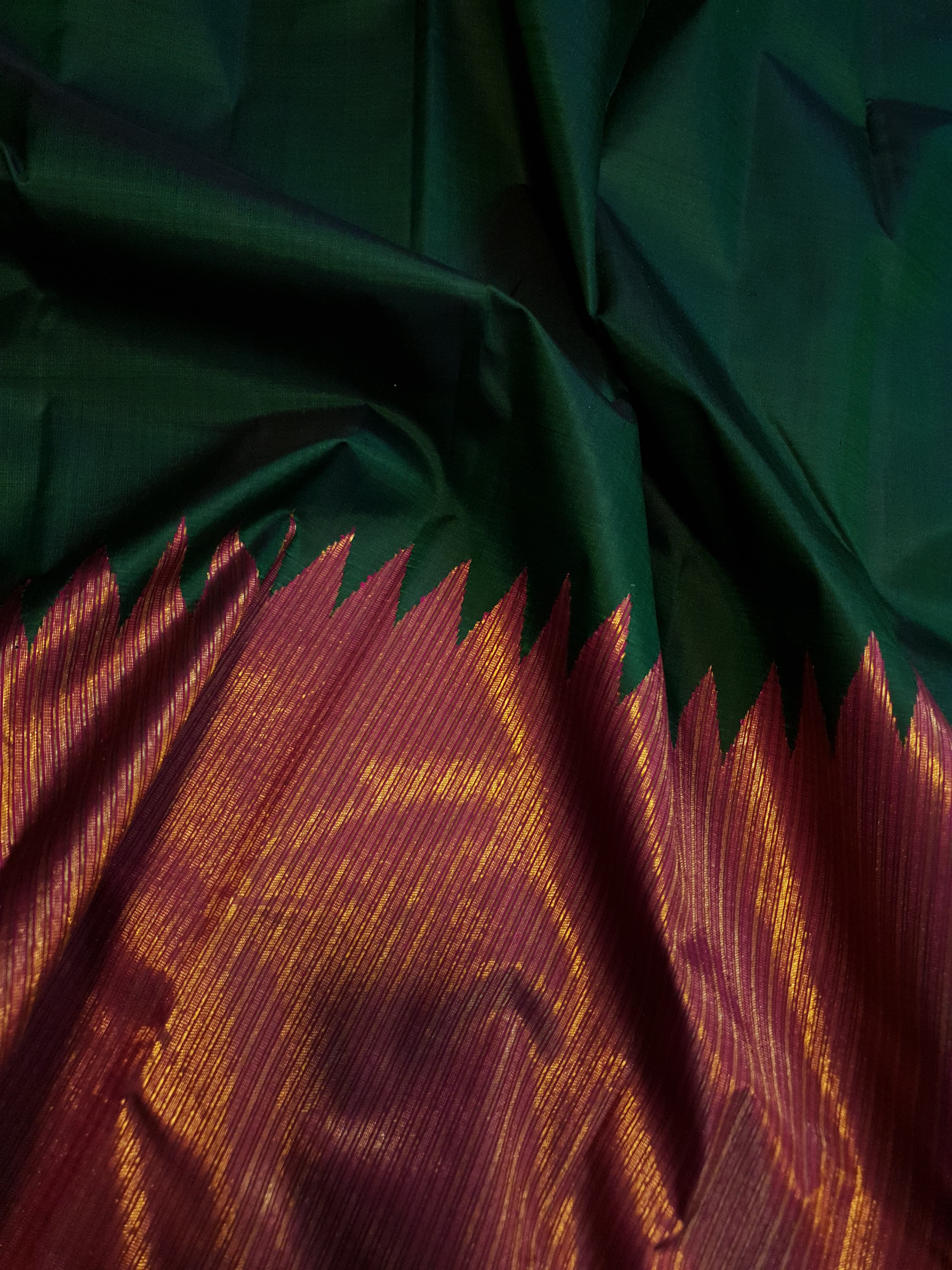 Bottle Green Kanchipuram handloom 2G gold temple silk saree featuring traditional gold zari weaving and classic temple borders.