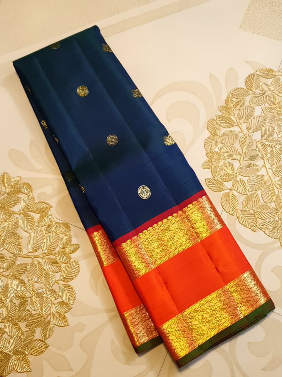 Midnight Blue Kanchipuram Handloom 2G Gold Korvai Silk Saree with contrasting orange gap borders and traditional motifs.